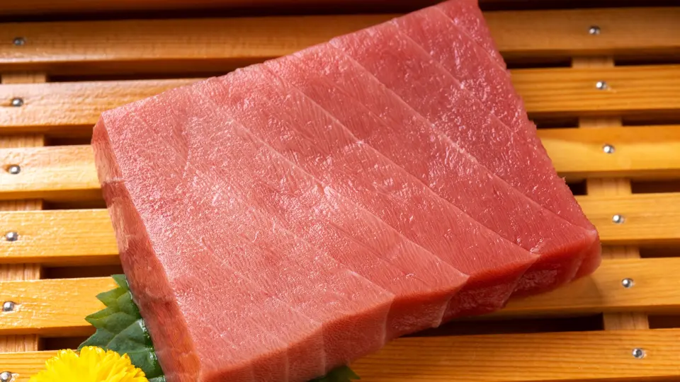 Fresh raw tuna on wooden table.