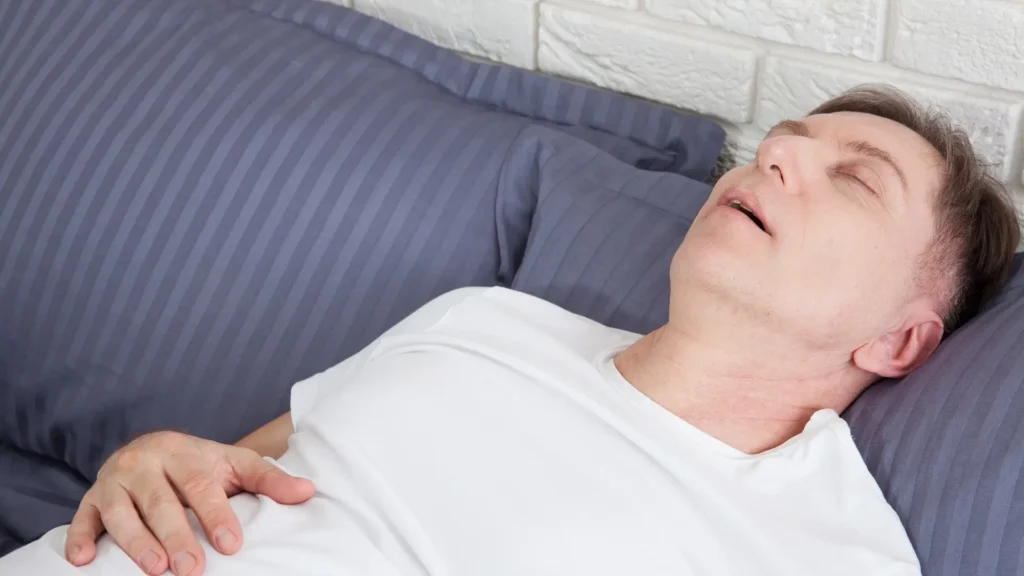 A man peacefully sleeping on a cozy couch.